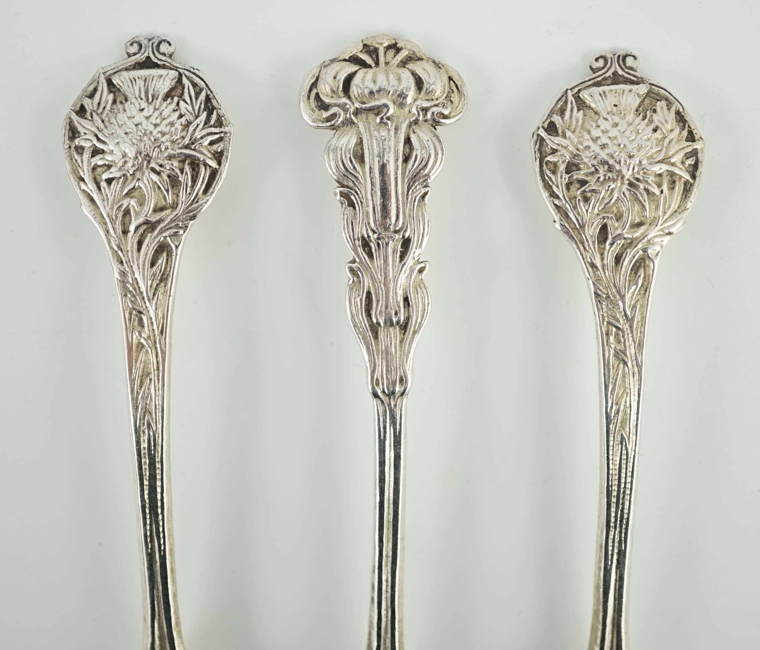 A cased set of three George V Arts & Crafts planished silver spoons by Omar Ramsden